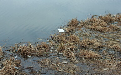 plastic wastes and garbage floating on the surface of the river, river pollution concept