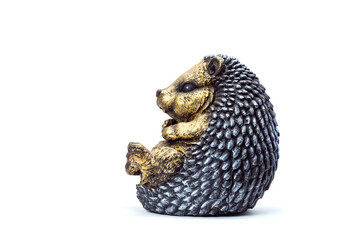 Obraz premium artificial concrete garden figure for landscaping and backyard decoration, isolated sedentary hedgehog side view on a white background, nobody.