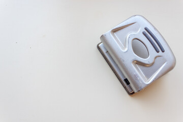 close up of a paper punch on a white background