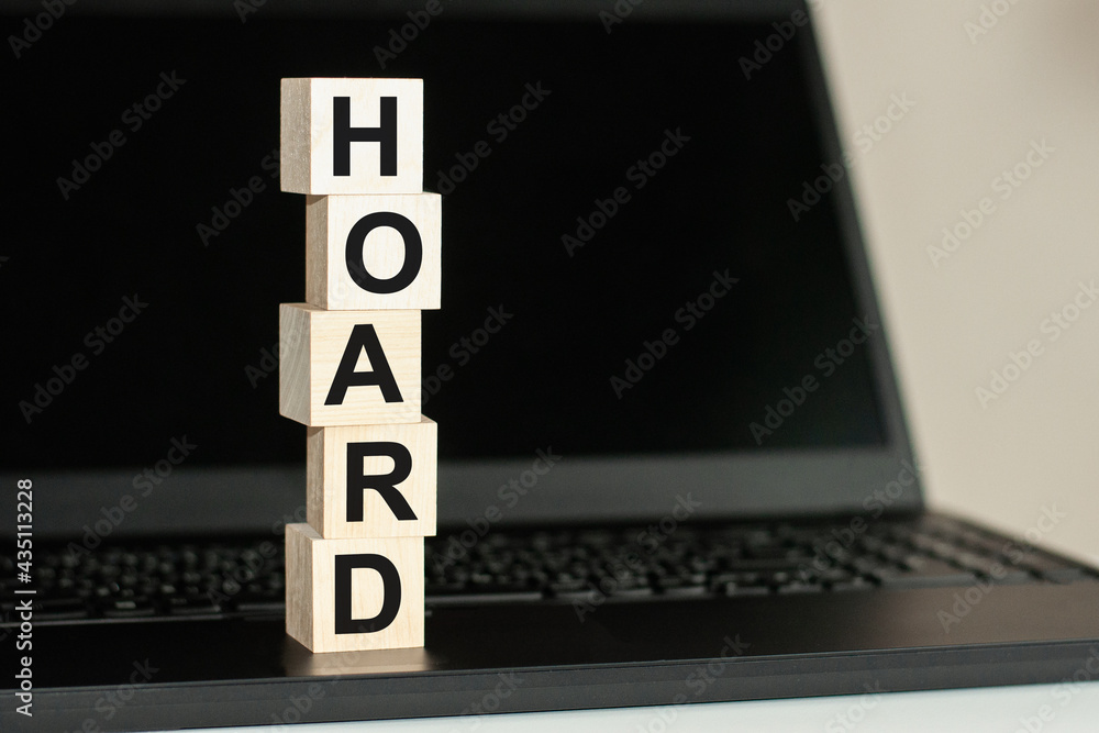 Fototapete hoard word made with building blocks on the black keyboard. a row of wooden cubes with a word writte