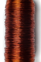 Copper wire coil close up. Copper wire of red color in a varnish sheath wound on a ferrite core.