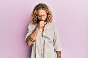 Handsome man with beard and long hair wearing casual clothes feeling unwell and coughing as symptom...