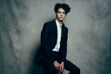 handsome guy curly hair suit self-confidence official