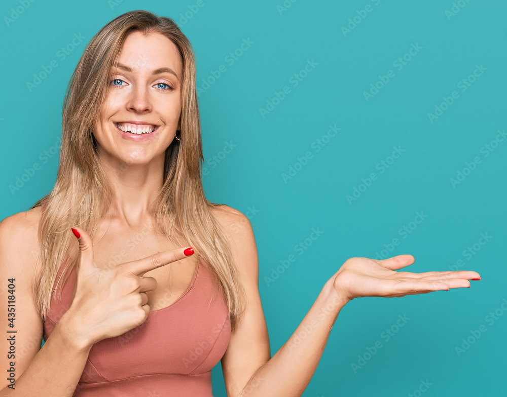 Poster beautiful caucasian woman wearing casual clothes amazed and smiling to the camera while presenting w