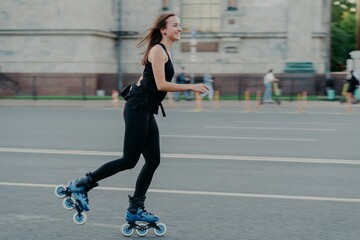 Rest leisure and lifestyle concept. Cheerful dark haired young European woman breathes fresh air...