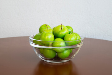 fresh green plum fruits on the table
