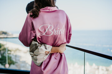 wedding details for bride and maid of honor pink and white bathrobes preparations	