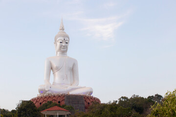 Big white buddha statue on mountain in Wat Roi Phra Phutthabat Phu Manorom for thai people and foreigner travelers travel visit and respect praying at Mukdahan National Park in Mukdahan, Thailand