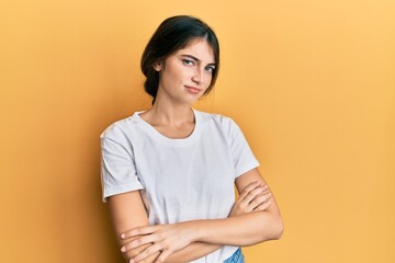 Obraz premium Young caucasian woman wearing casual white t shirt skeptic and nervous, disapproving expression on face with crossed arms. negative person.