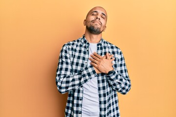 Hispanic adult man wearing casual clothes smiling with hands on chest, eyes closed with grateful gesture on face. health concept.