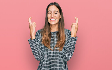 Young beautiful woman wearing casual clothes gesturing finger crossed smiling with hope and eyes closed. luck and superstitious concept.