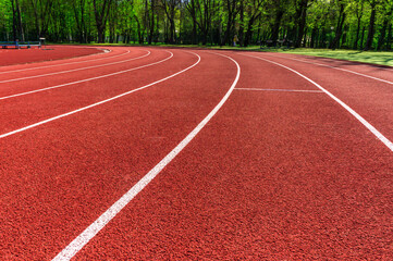 Running Track. Red treadmills at the stadium.Red racetracks on the sports arena. Stadium.