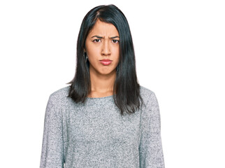 Beautiful asian young woman wearing casual clothes skeptic and nervous, frowning upset because of...