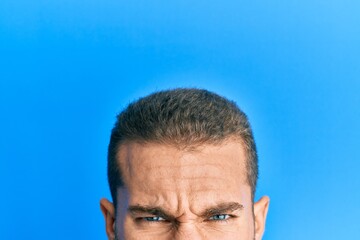 Young caucasian man showing head and half face skeptic and nervous, frowning upset because of...
