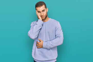 Young caucasian man wearing casual clothes thinking looking tired and bored with depression problems with crossed arms.