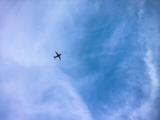 Airplane flying in the blue summer sky