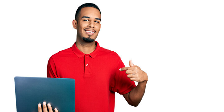 Young african american man working using computer laptop pointing finger to one self smiling happy and proud