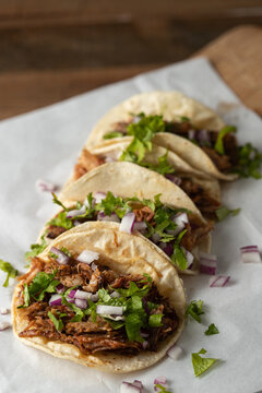 Authentic Mexican barbacoa tacos with cilantro and onion served on corn tortillas