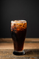 glass of coke on wooden table