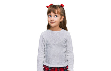 Little caucasian girl kid wearing casual clothes smiling looking to the side and staring away thinking.