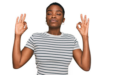 Young african american woman wearing casual clothes relax and smiling with eyes closed doing meditation gesture with fingers. yoga concept.