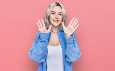 Young blonde girl wearing casual clothes showing and pointing up with fingers number nine while smiling confident and happy.