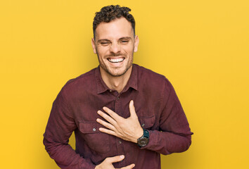 Young hispanic man wearing casual clothes smiling and laughing hard out loud because funny crazy...