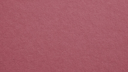 The surface of dark red cardboard. Puce paperboard wallpaper. Paper texture with cellulose fibers. Purple-brown tinted background. Beautiful textured backdrop. Top-down. Macro