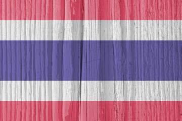 The flag of Thailand on dry wooden surface, cracked with age. Light pale faded paint. Background, wallpaper or backdrop with Thai national symbol. Old wood. Hard sunlight with shadows