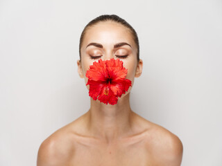 Fototapeta na wymiar attractive woman with closed eyes flower mouth naked shoulders isolated background