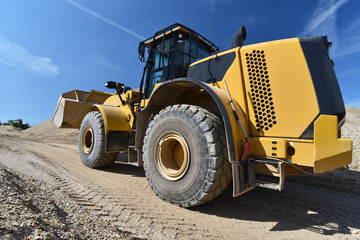 heavy construction machine in open-cast mining - wheel loader transports gravel in a gravel plant