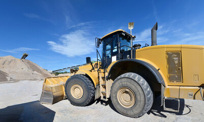 heavy construction machine in open-cast mining - wheel loader transports gravel in a gravel plant