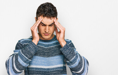 Hispanic young man wearing casual clothes with hand on head for pain in head because stress....