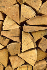 vertical wooden pattern of chopped firewood stacked in a pile for the whole frame