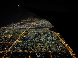 View of The night lit up city from the airplane window