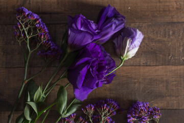 bunch of lilac flowers on wooden background