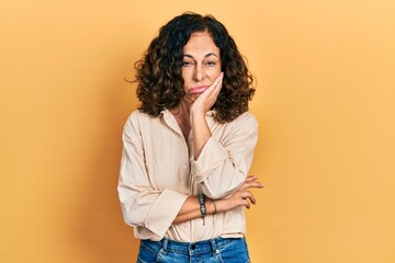 Middle age hispanic woman wearing casual clothes thinking looking tired and bored with depression problems with crossed arms.