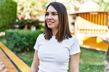 Young beautiful woman smiling happy outdoors on a sunny day of summer