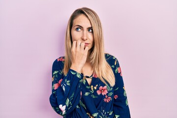 Young caucasian woman wearing casual clothes looking stressed and nervous with hands on mouth...