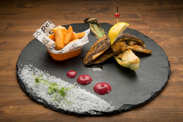 Baked seabream.with a garlic butter and white wine marinade,served with potatos.