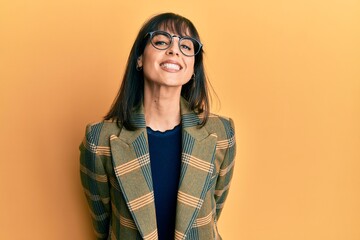 Young hispanic woman wearing business style and glasses with a happy and cool smile on face. lucky person.