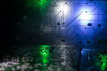 Stylized photo of an electronic microcircuit. Microcircuit, contacts, electronics, motherboard. Black background. Macro photography of electronic devices.