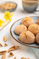 Almond cookies and a cup of coffee on a white concrete background Side view, selective focus.