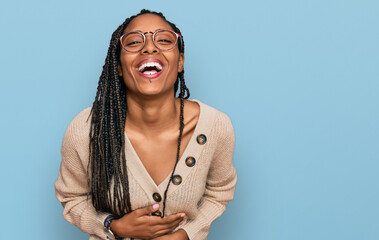 African american woman wearing casual clothes smiling and laughing hard out loud because funny...