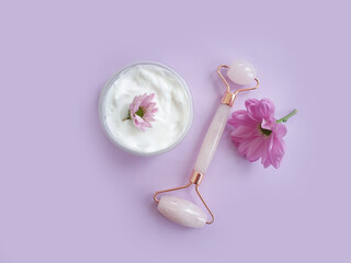 massage roller, flower on a colored background

