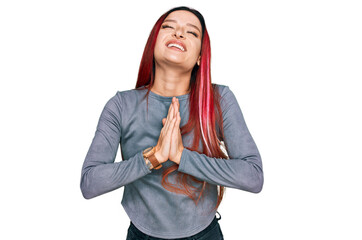 Young caucasian woman wearing casual clothes begging and praying with hands together with hope...