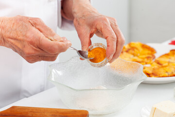 Senior woman preparing a traditional dish from el Valle del Cauca in Colombia called aborrajado