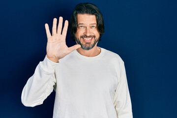 Middle age caucasian man wearing casual clothes showing and pointing up with fingers number five...