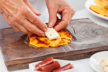 Senior woman preparing a traditional dish from el Valle del Cauca in Colombia called aborrajado
