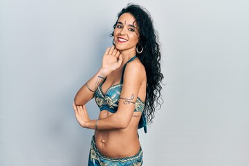 Young indian woman wearing traditional belly dancer costume. Dancing exotic oriental dance with body and hands